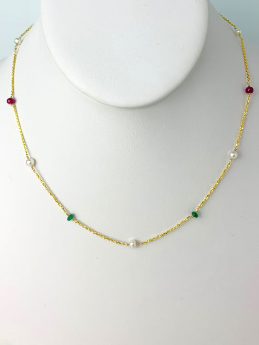 smooth ruby emerald and sapphire beads alternating with round white pearls in stations around a yellow gold chain