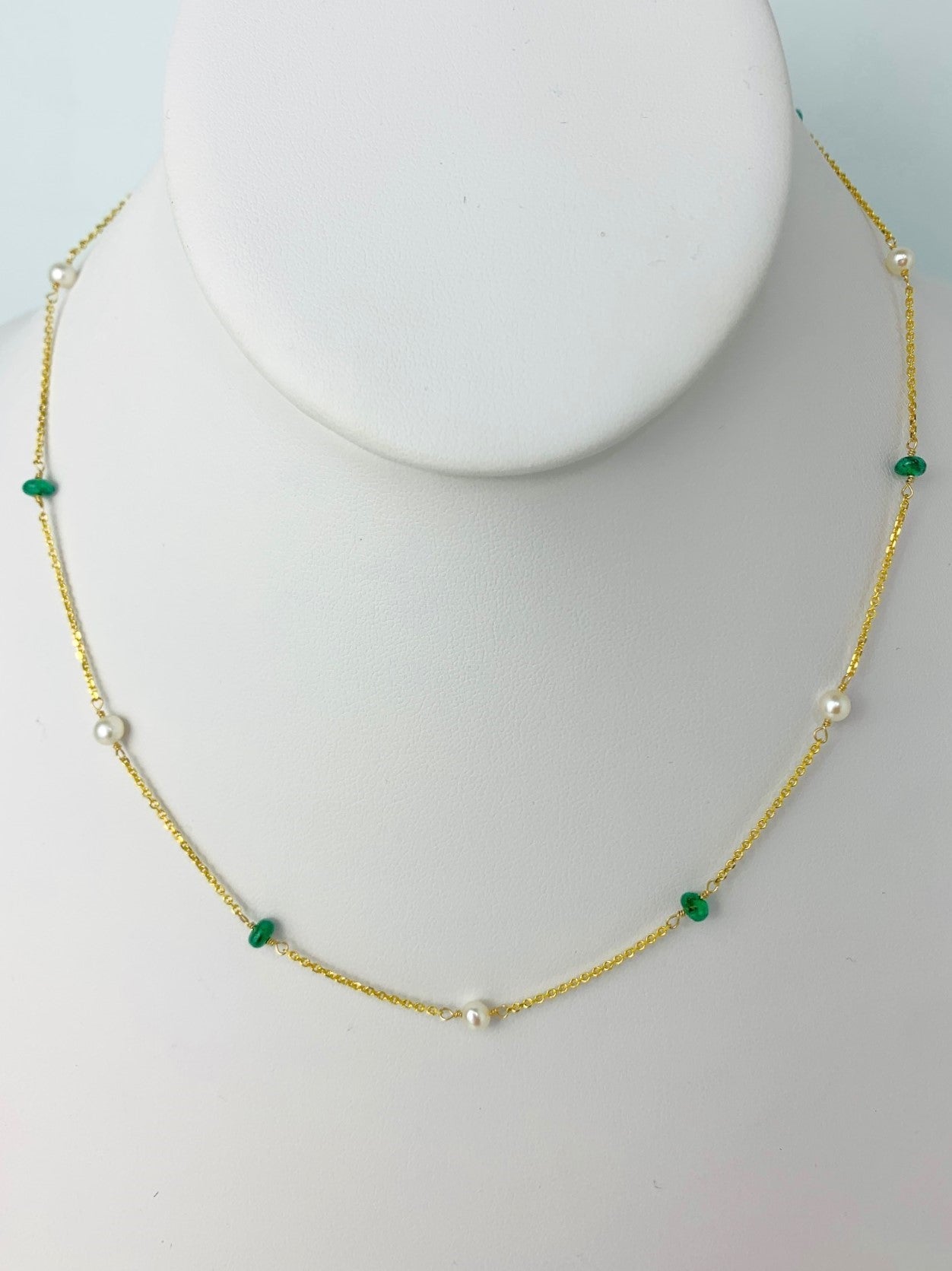 emerald beads and white round pearls in stations around a yellow gold chain